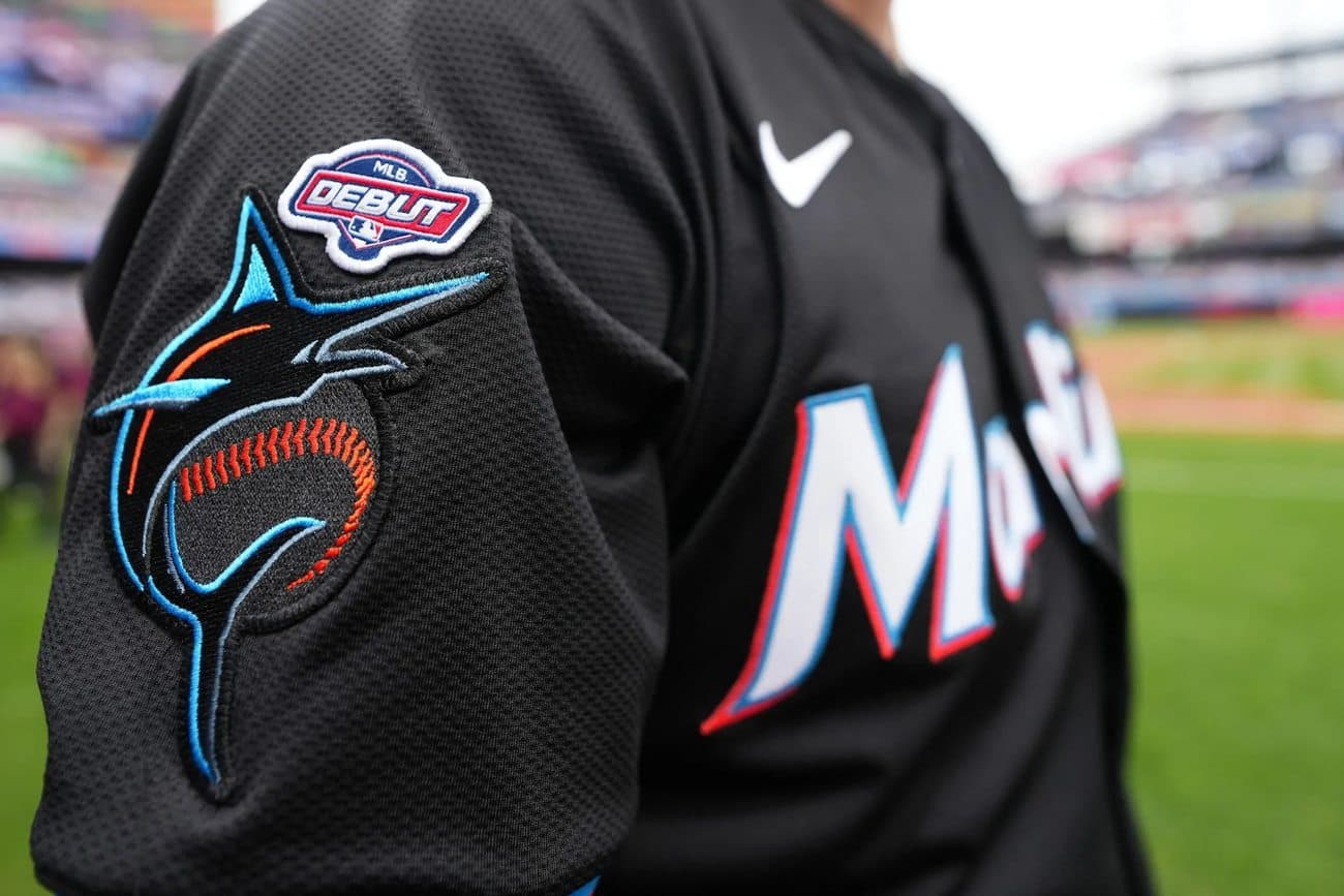 Close-up of an MLB Debut patch stitched to the sleeve of a Miami Marlins jersey on the field