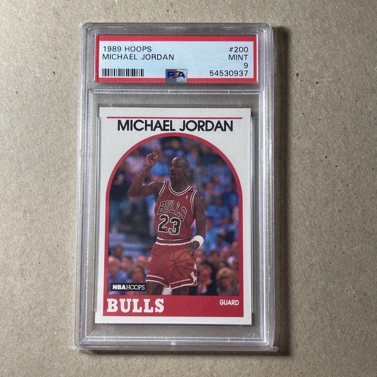 A 1989-90 NBA Hoops Michael Jordan card, number 200, in a PSA 9 slab