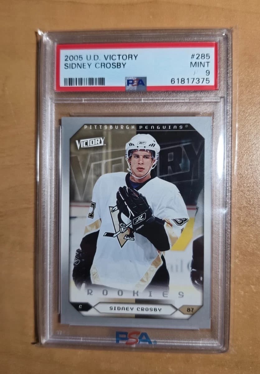 A 2005-06 Upper Deck Victory Sidney Crosby rookie card, number 285, in a PSA 9 slab