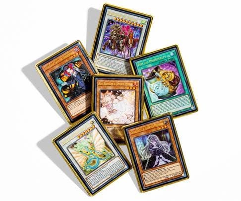 Six Yu-Gi-Oh! trading card pins with gold borders