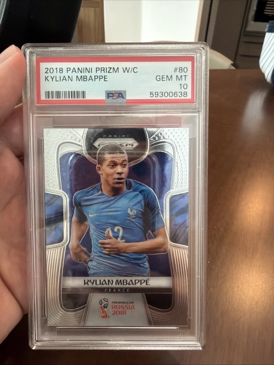 A 2018 Panini Prizm World Cup Kylian Mbappé rookie card, number 80, in a PSA 10 slab