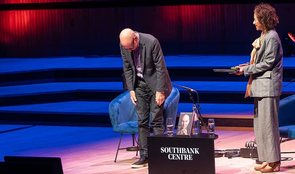 Patrick Stewart takes a bow on stage beside Samira Ahmed at the Royal Festival Hall in London, Oct. 21, 2023.