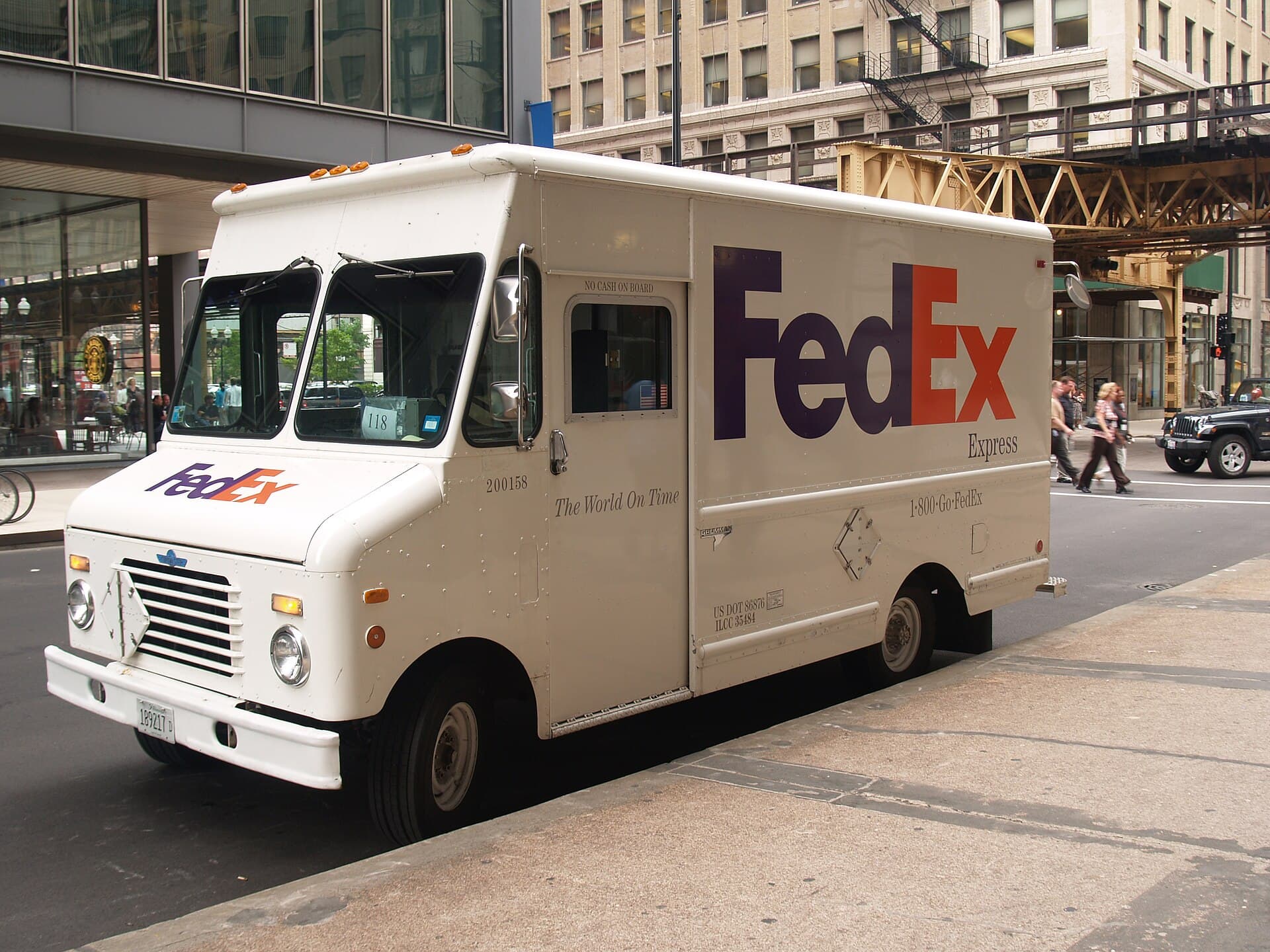 A FedEx Express delivery truck parked on a downtown Chicago street.