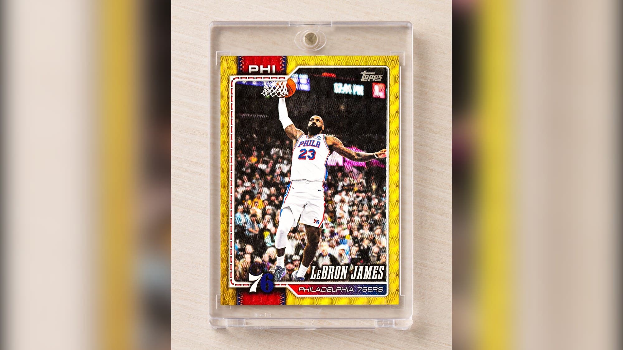 LeBron James's 2026-27 Topps Flagship Basketball card as a Philadelphia 76er, a gold parallel in a magnetic holder, from Topps' Oct. 19 announcement