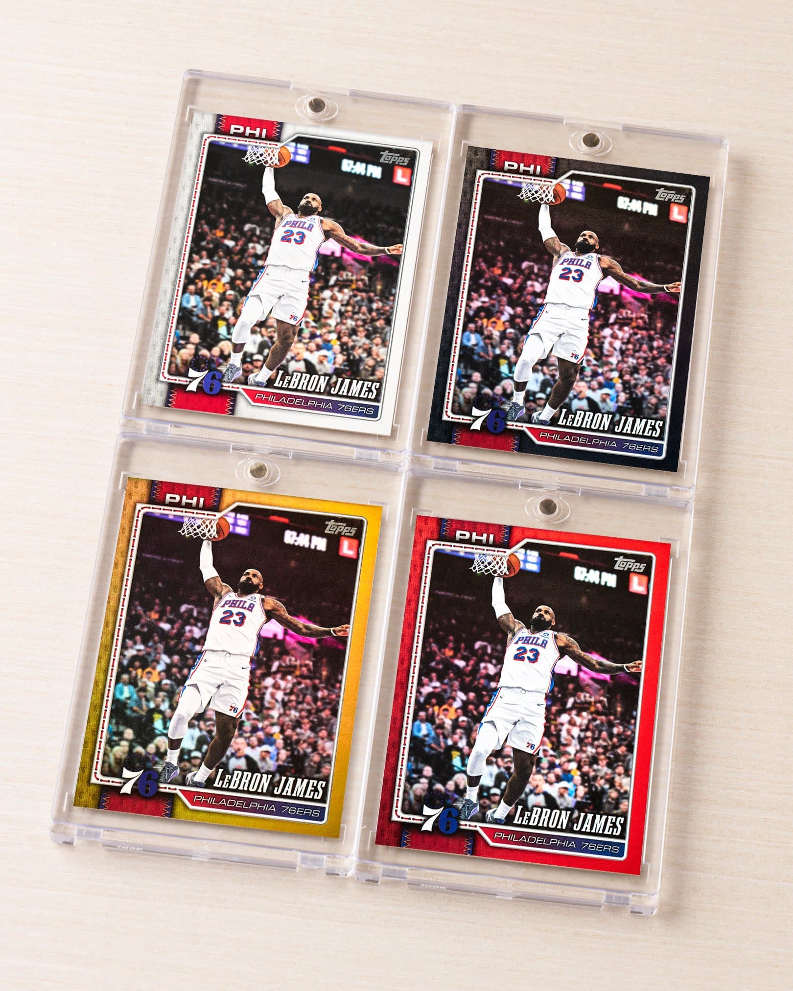 Four LeBron James 2026-27 Topps Flagship Basketball cards as a Philadelphia 76er, in white, black, gold and red parallels, from Topps' Oct. 19 announcement