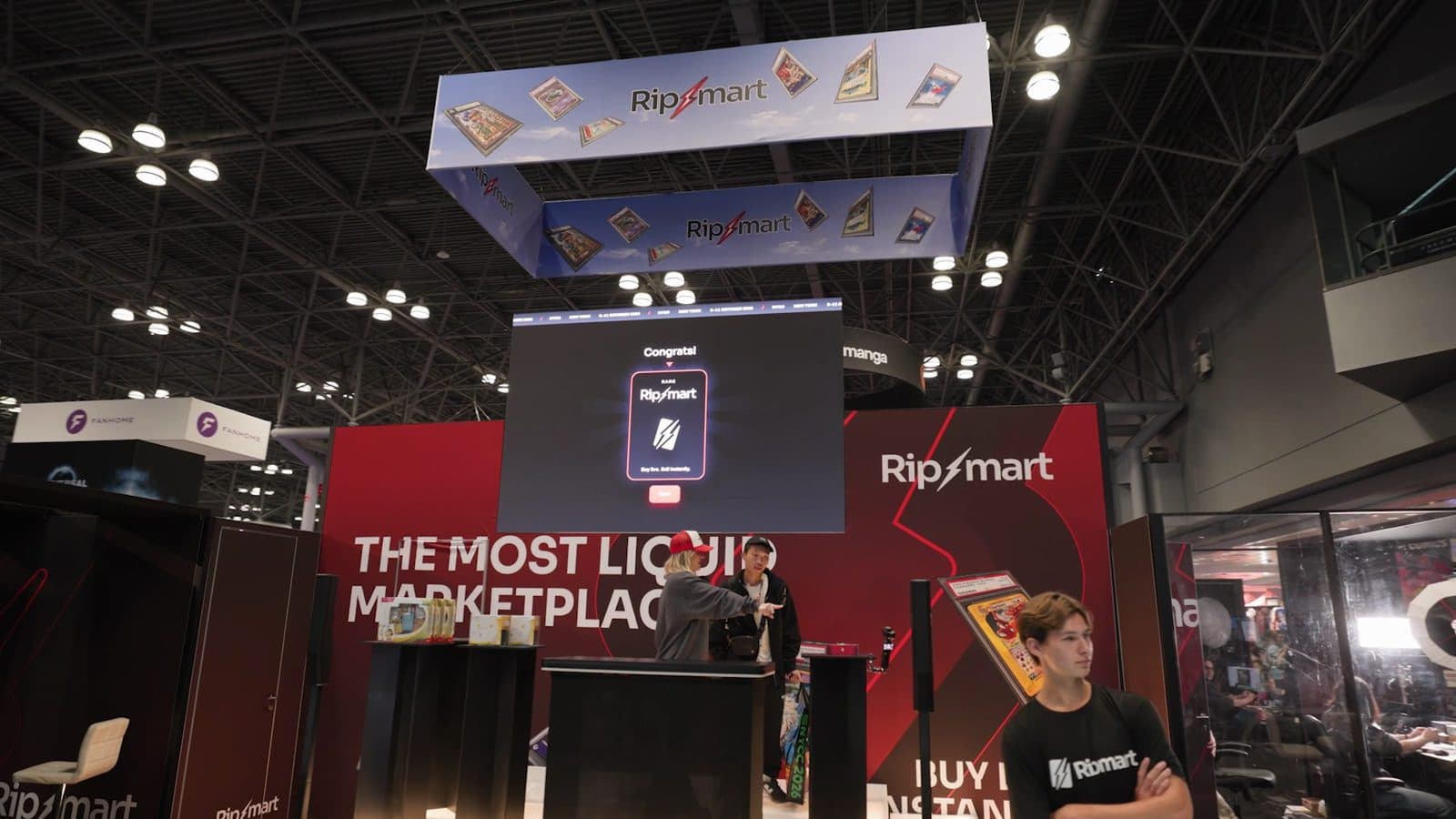 The Ripmart booth at New York Comic Con, with a wall reading The Most Liquid Marketplace and a screen showing a card reveal