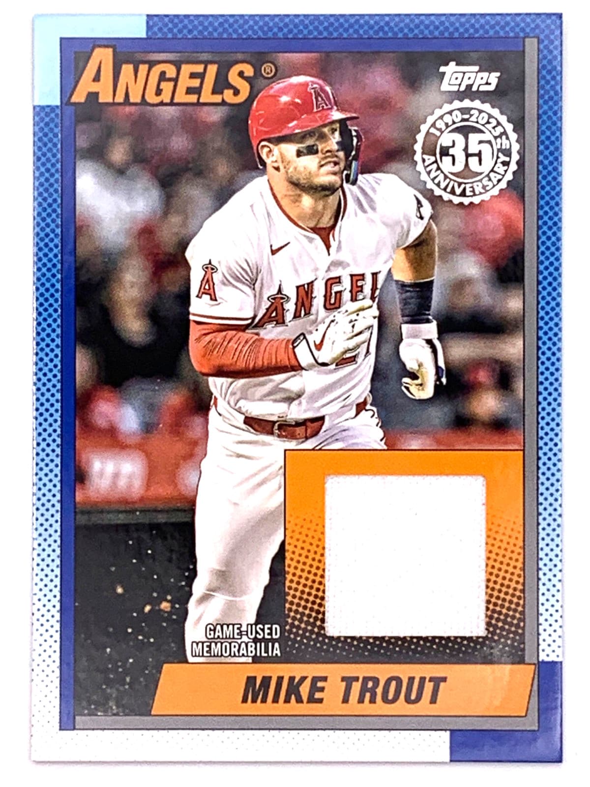 A 2025 Topps Update Mike Trout 1990 Topps relic card with a white game-used jersey swatch in an orange window.