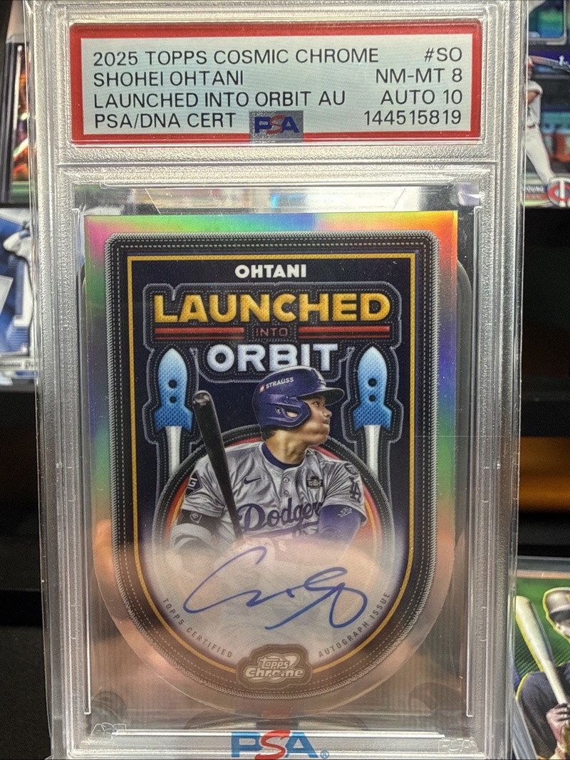 Shohei Ohtani 2025 Topps Chrome Cosmic Launched Into Orbit autograph, PSA 8, an example of his Chrome autograph class, not the jersey or any of the three cards named above. Photo: eBay listing.